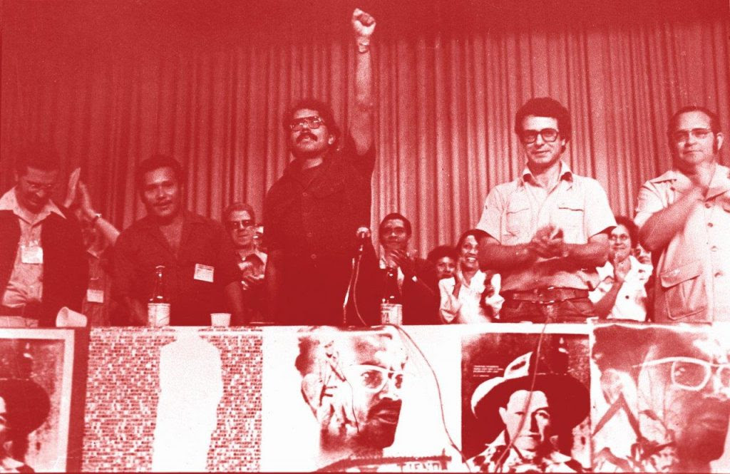 De punho cerrado (saudação comunista), Daniel Ortega, sob os aplausos de Frei Uriel Molina (primeiro à esq.), Frei Betto (do lado esq. de Ortega) e o Padre Miguel DâEscoto (à dir.)