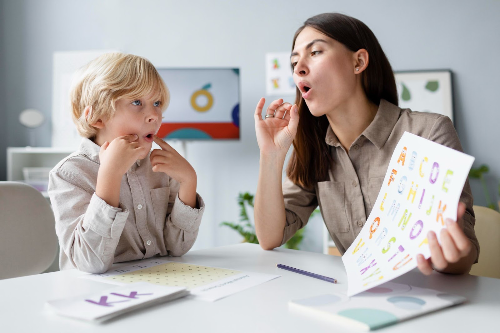 A woman teaching a kid pronunciation