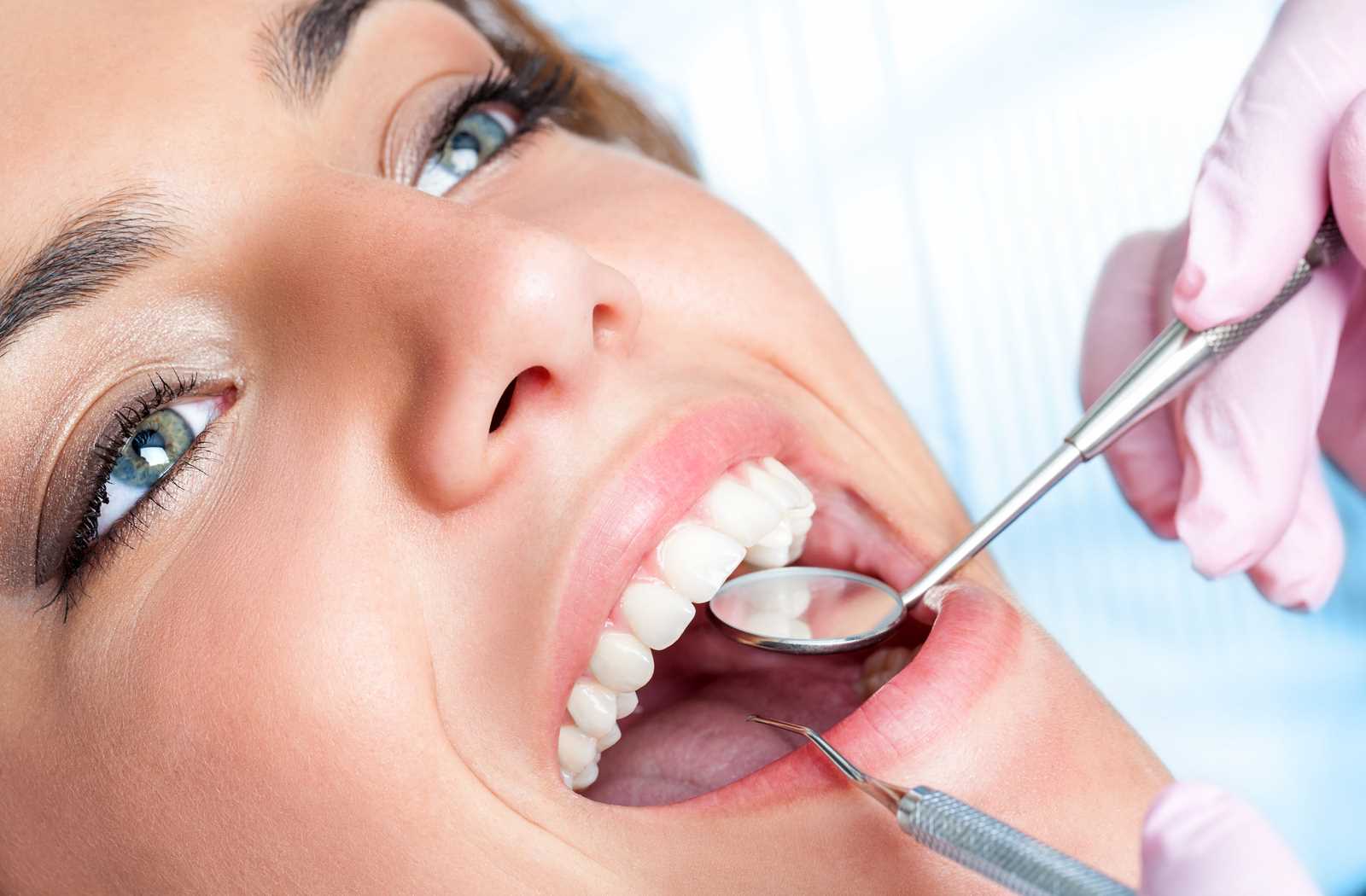 young woman enjoying dental exam in saturated white exposure