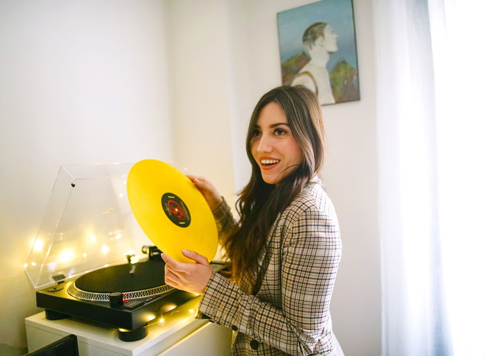 Woman holding a yellow vinyl record: How To Get Your Music Heard By Record Labels