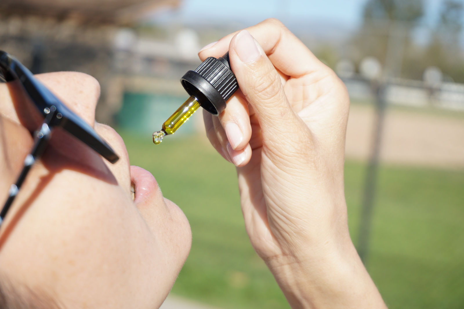 Is CBD legal? Yes. Here's a woman taking CBD oil.