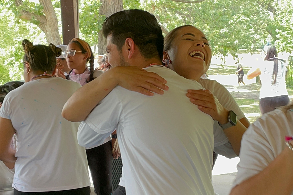 teachers hugging each other, modeling health relationships