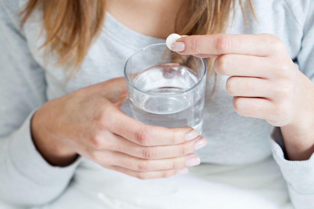 Woman taking a sleeping pill