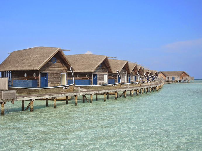 a row of houses on a dock over water