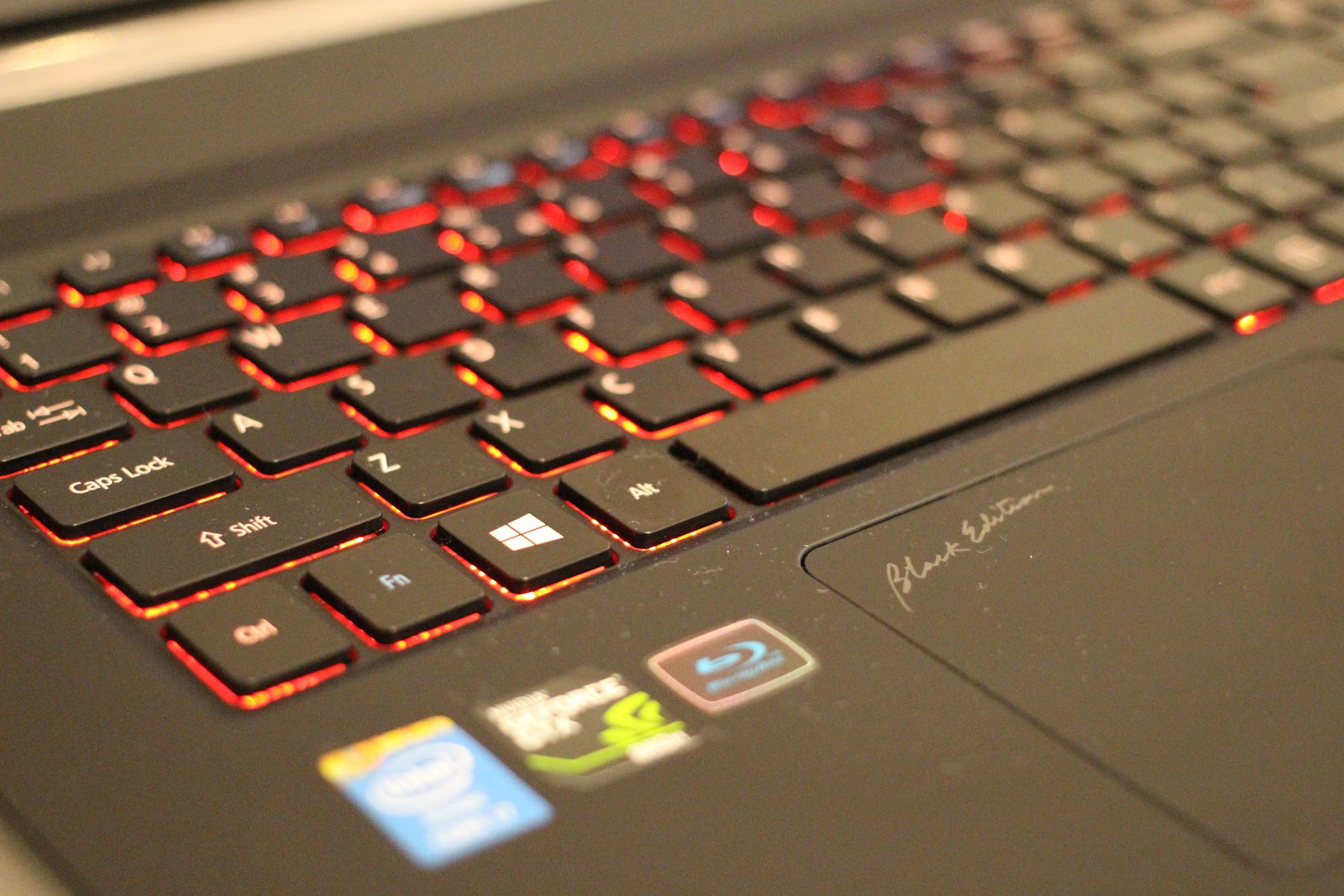 This image shows the half keyboard of ASUS ROG laptop with red  light.