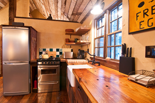 Rustic wood counter tops bring character, functionality and durability to this small kitchen.