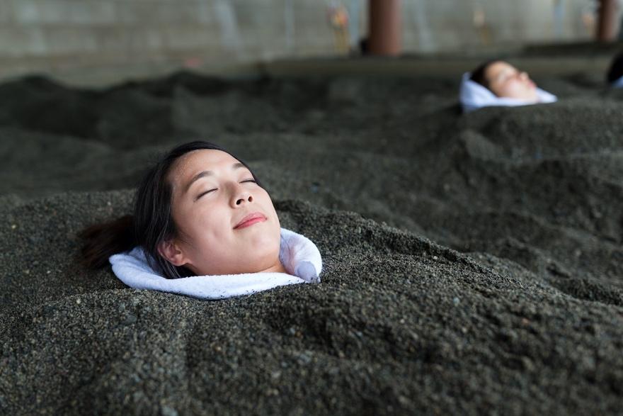 A young girl lying on the ground

Description automatically generated