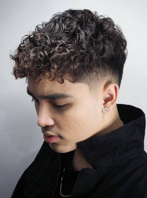 man wearing curly hair with fade