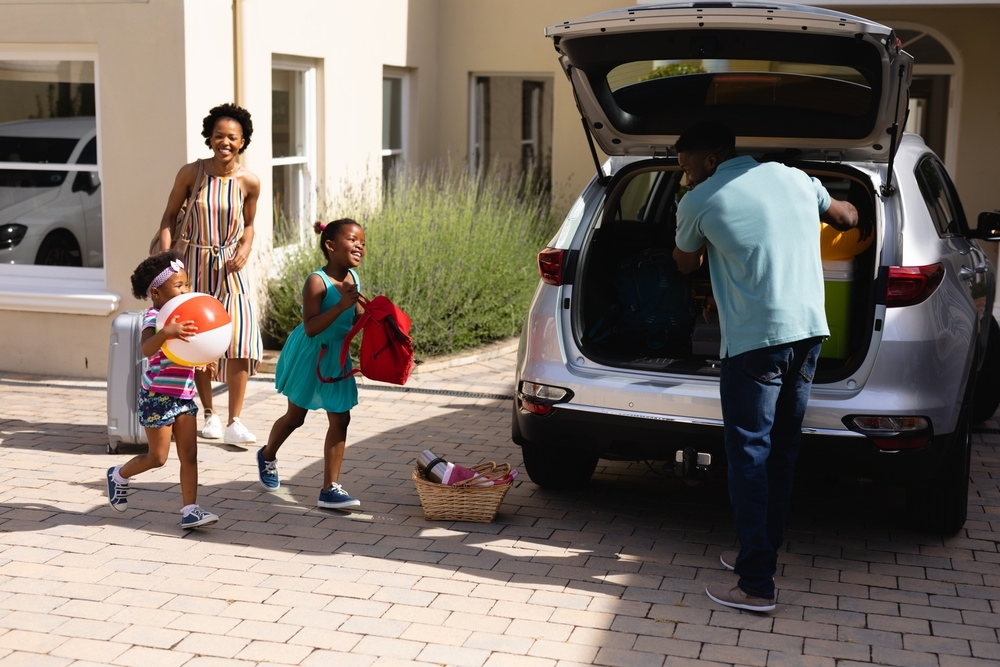 A family loads up their car to go on a trip