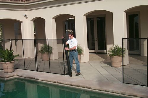 All-Safe pool fence installer completing installation on a pool fence