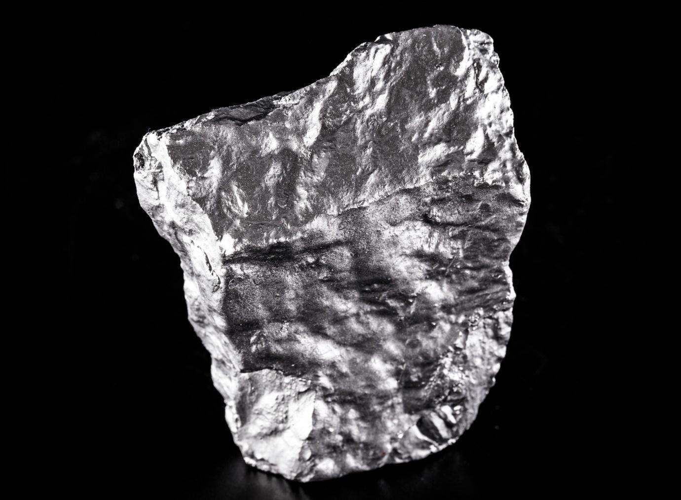 Silvery rock against a black background