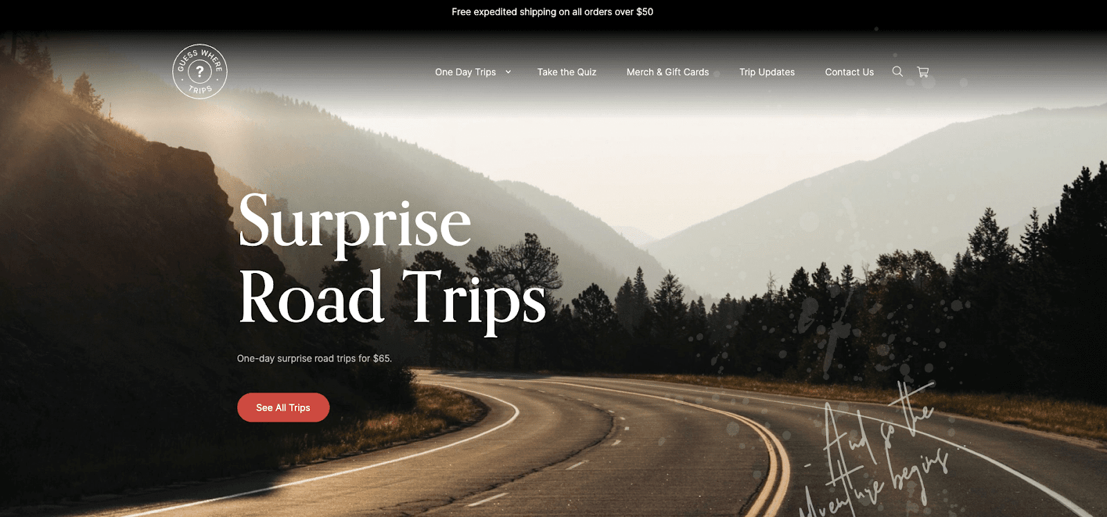 Valentine’s Day Gift Guide–A screenshot from Guess Where Trips’ homepage. There is an image of a curved road, with forests and mountains in the background. In the foreground, the text says, “Surprise Road Trips. One-day surprise trips for $65”. There is a red button with white text that says, “See All Trips”. 