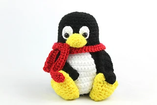 crochet penguin with red scarf