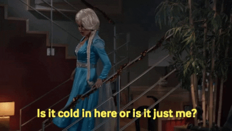 A GIF of a woman dressed as Elsa from Frozen asking, "Is it cold in here or is it just me?"