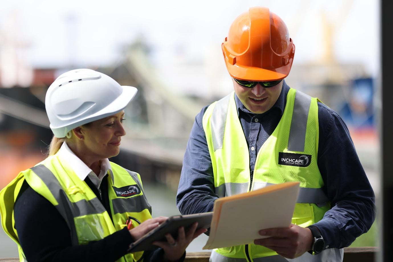 Men wearing hard hats looking at a tablet

Description automatically generated with low confidence