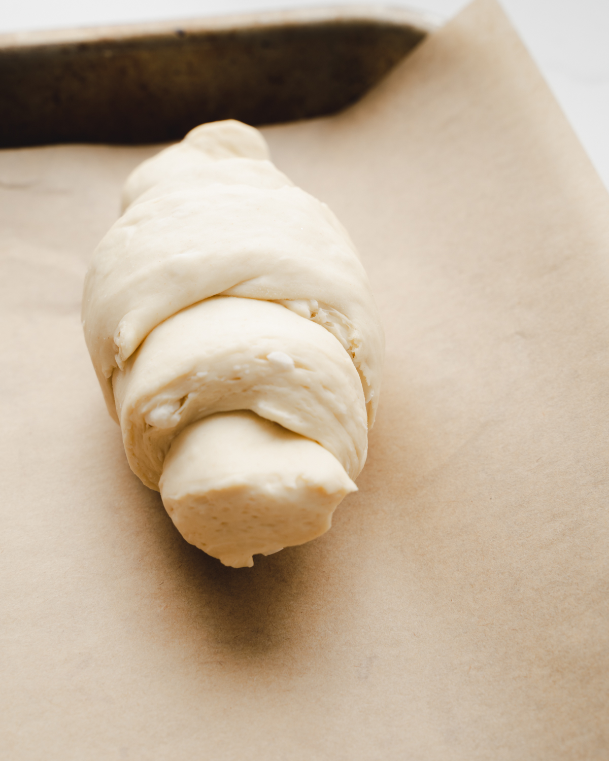 vegan croissant resting on a baking sheet