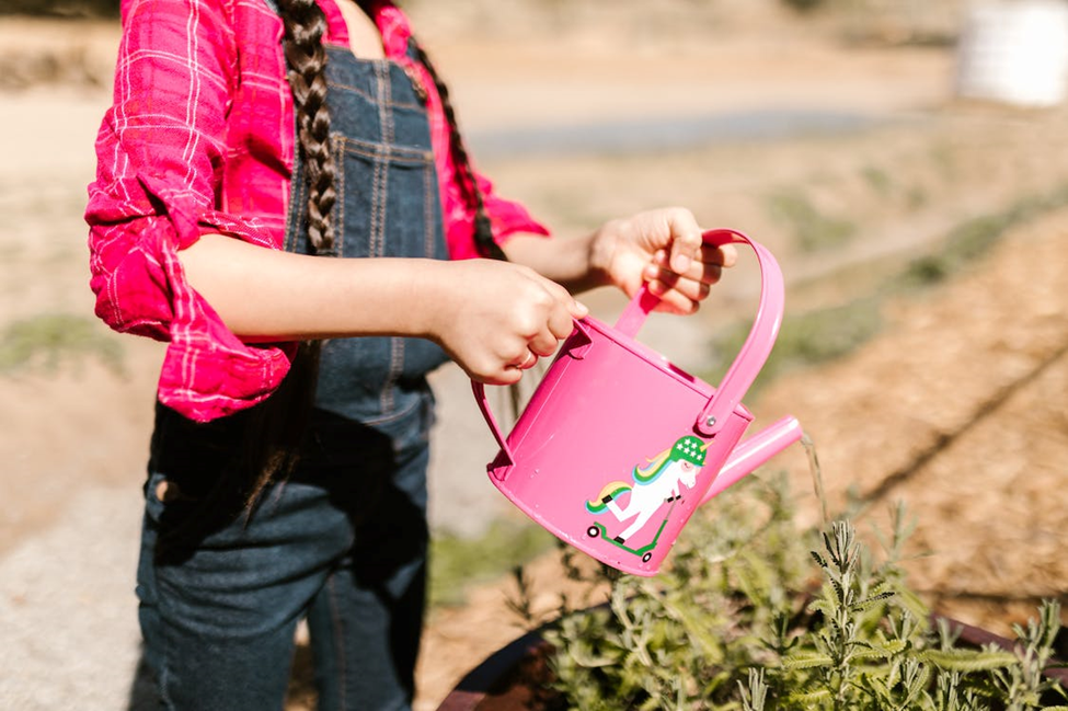 Sustainability education girl with watering can