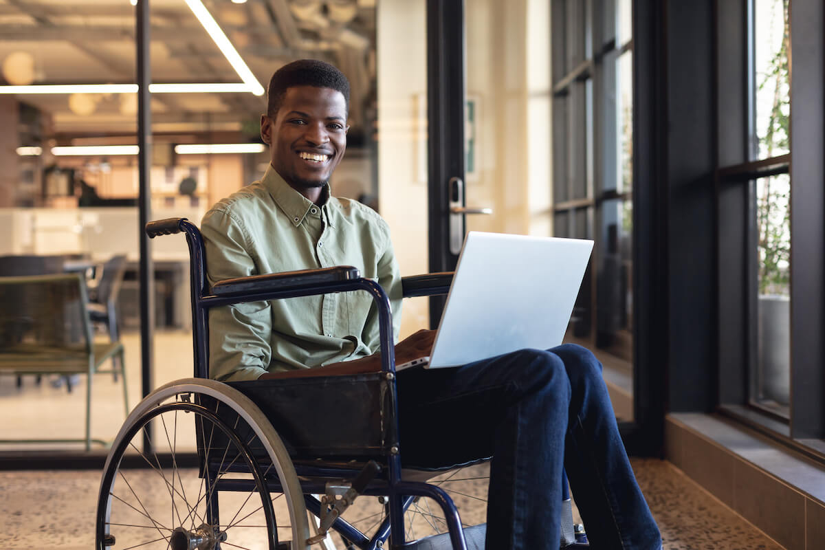 Man in a wheelchair happily working