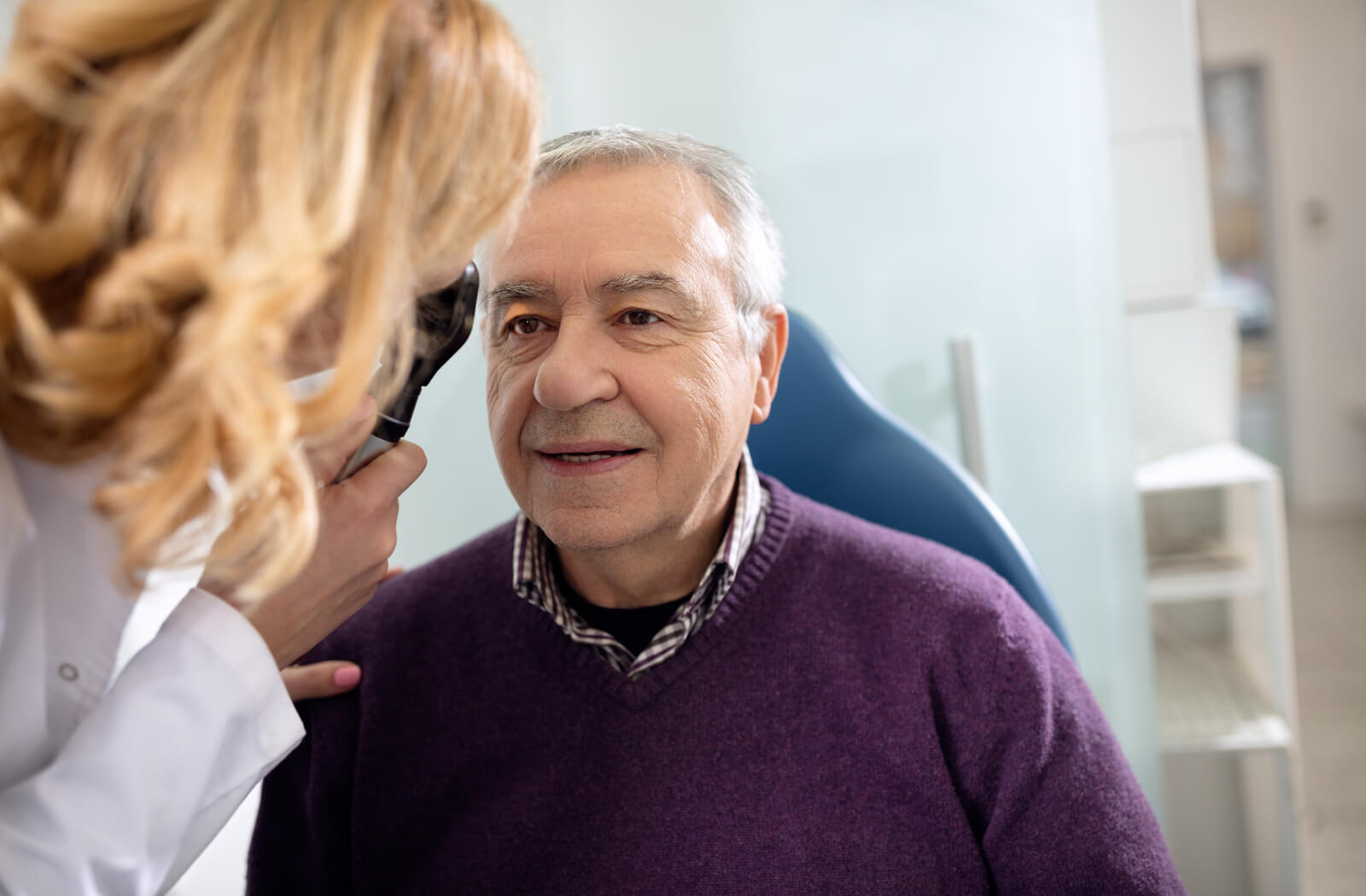 a man has his eye examined by his eye doctor