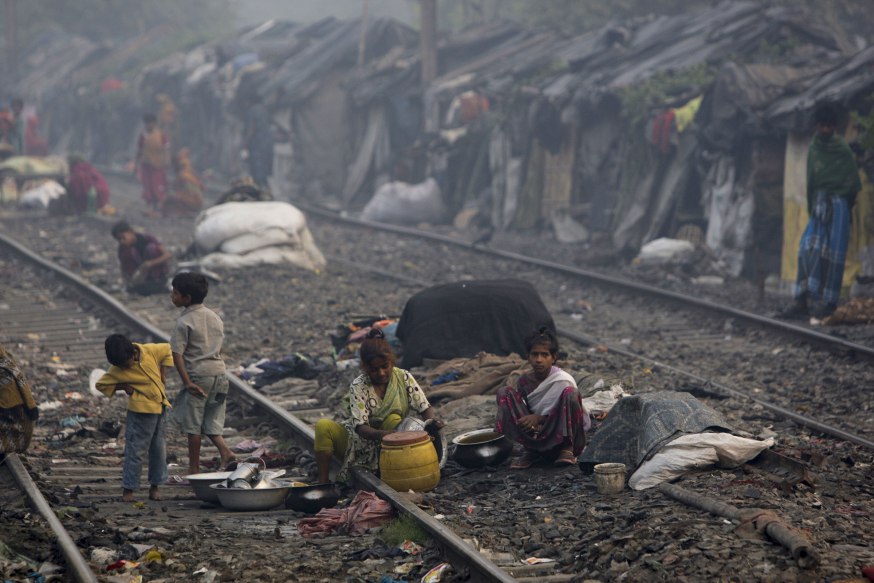 KOLKATA, INDIA - NOVEMBER 12:  Slum dwellers live by a railroad track Kolkata, India. India's slum population is projected to rise to 93.06 million by 2011, or 7.75 percent of the total population, according to a report of an expert committee set up by the housing and urban poverty alleviation ministry.  (Photo by Kuni Takahashi/Getty Images)