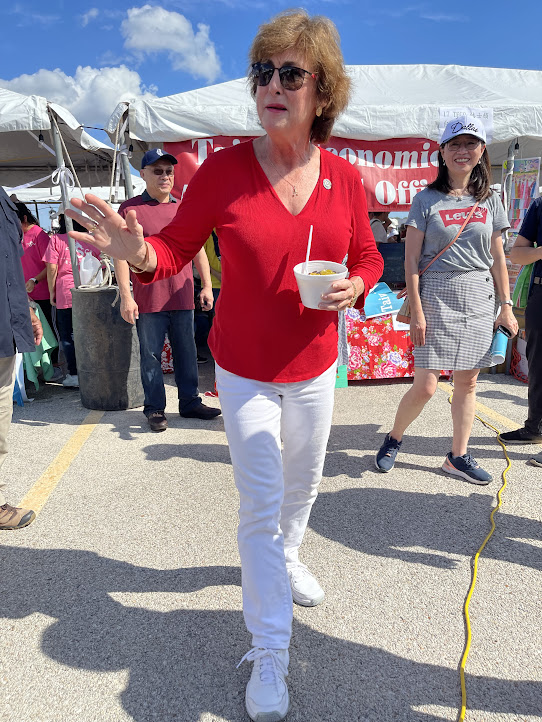 A person in a red shirt holding a bowl of food

Description automatically generated