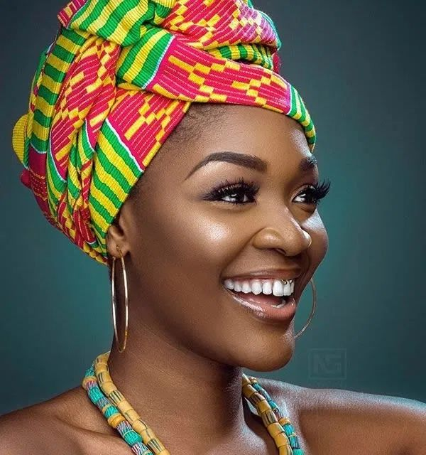 Black woman wearing an ankara head wrap.