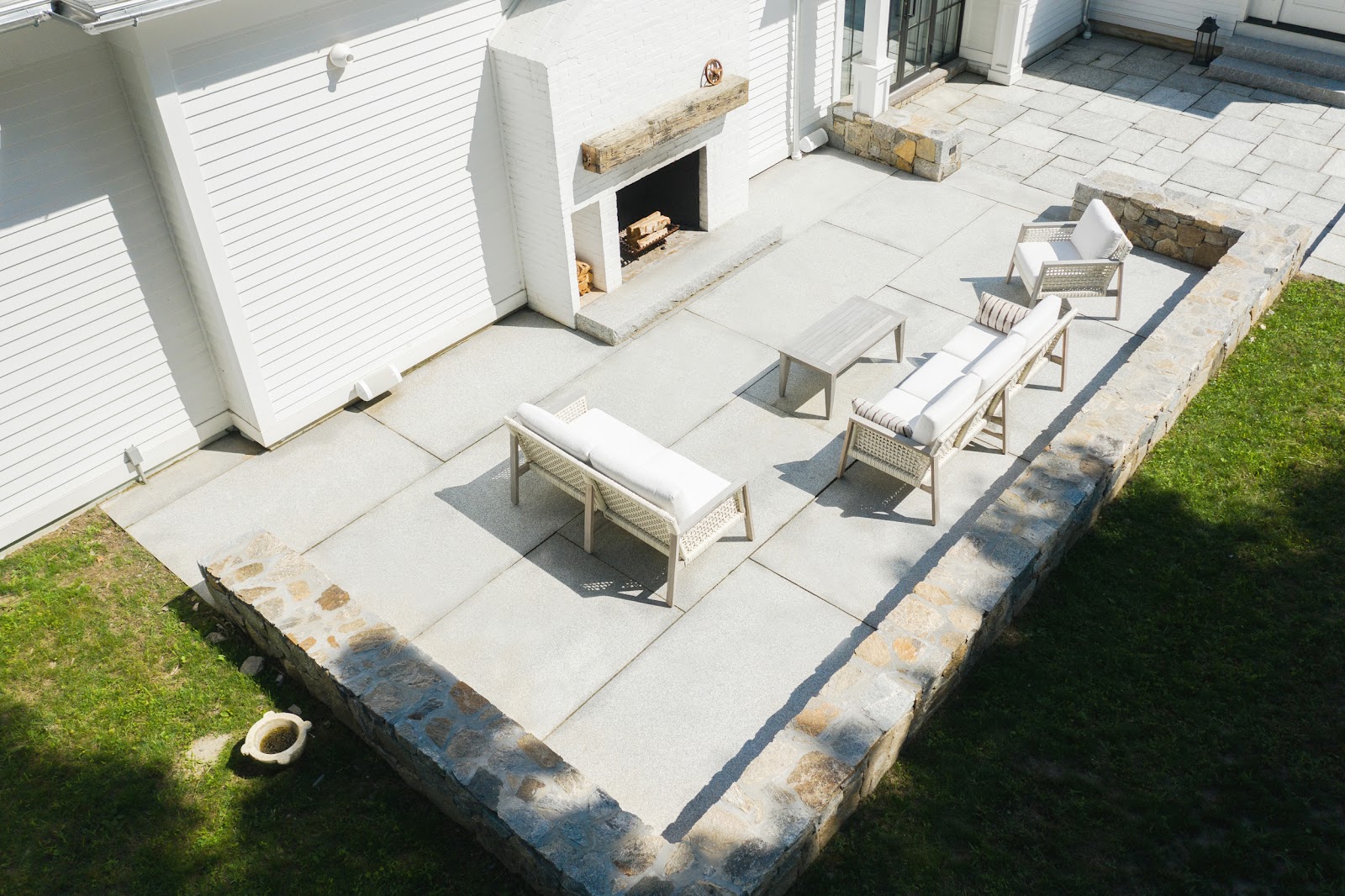 This contemporary patio features large Woodbury Gray granite pavers