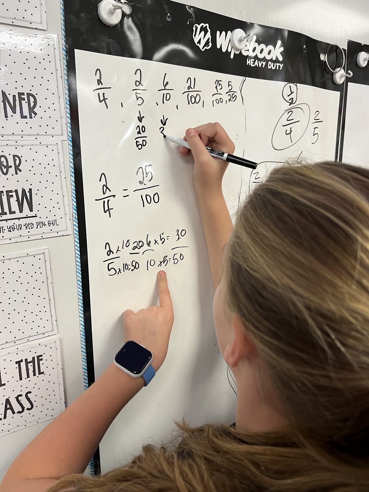 A student works through a math problem on a Flipchart