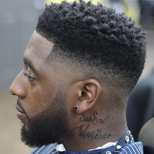 man with tattoos wearing high fade with short hair