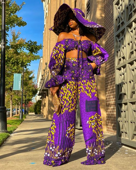 lady wearing a wide-brimmed ankara hat with a matching crop top  and palazzo