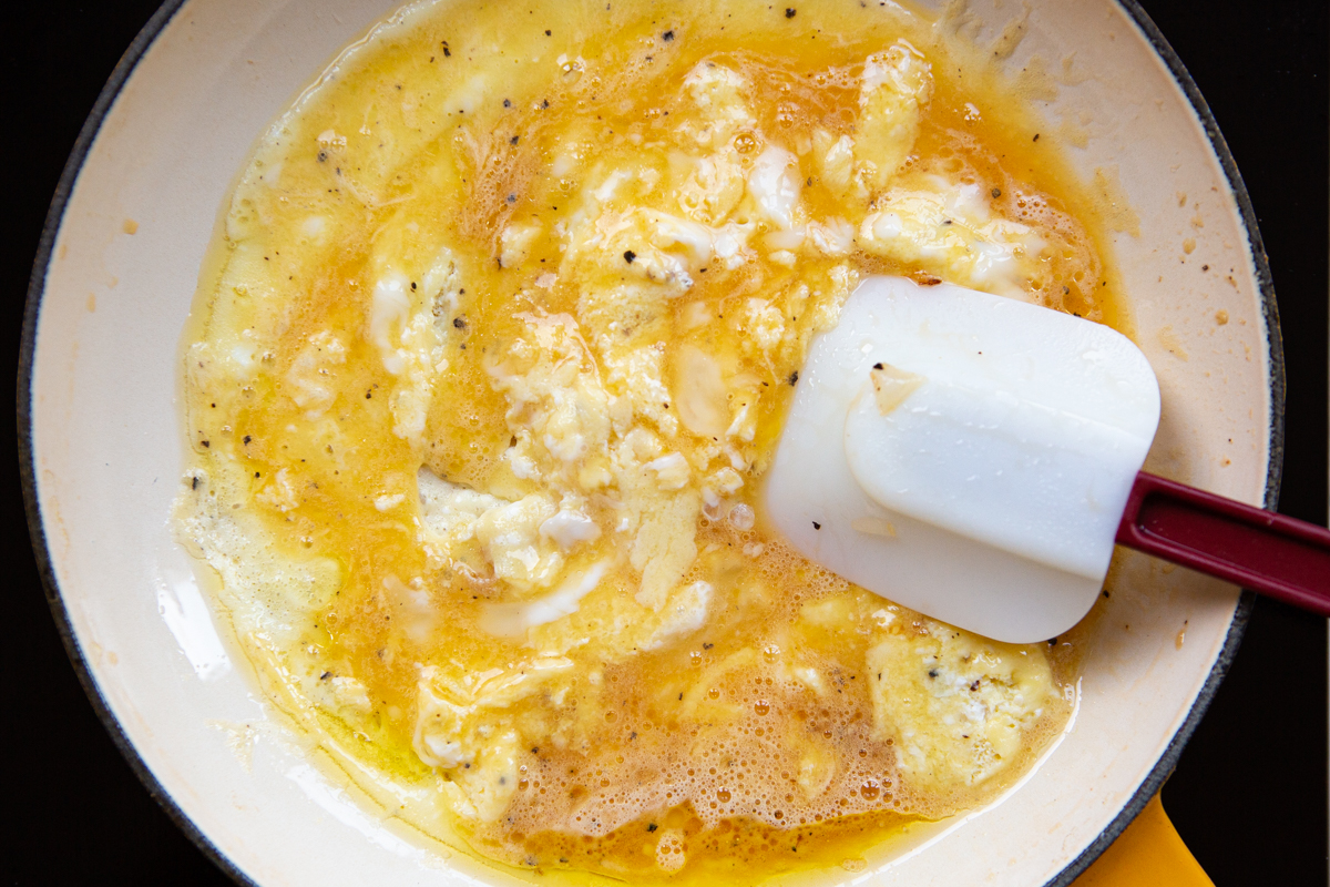 beaten eggs added on a nonstick pan