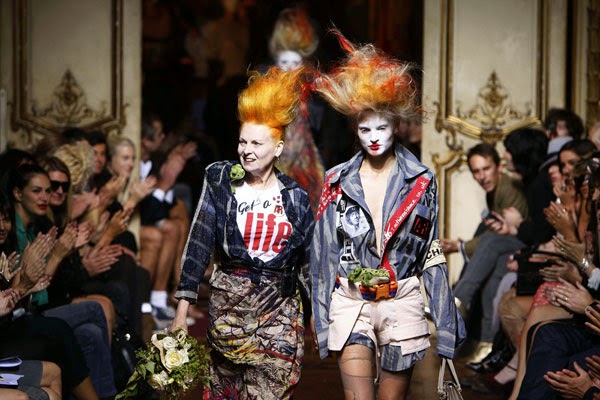 Vivienne Westwood with one of her models walking down the catwalk