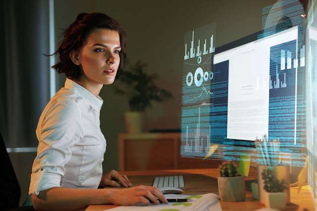 An adult working on a holographic screen, showing how computer science helps kids in future careers