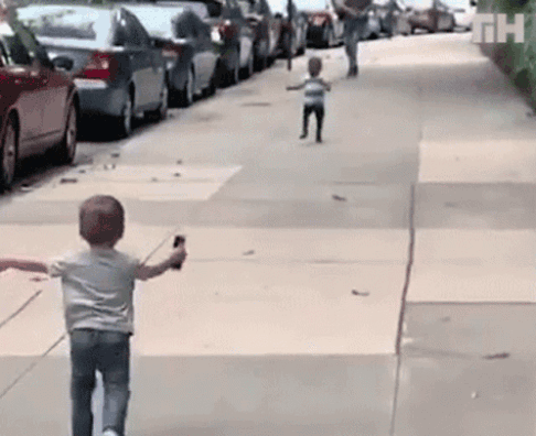 Gif of two children with opposite skin color running into each other's arms.