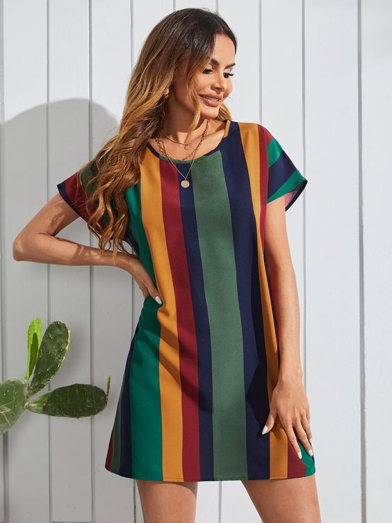 A lady in a multicolored striped short dress