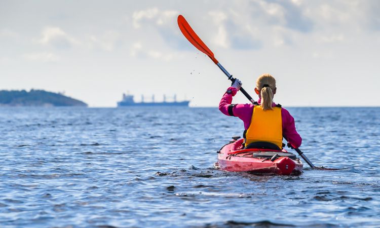 When deciding what to wear while kayaking, what should you keep in mind?