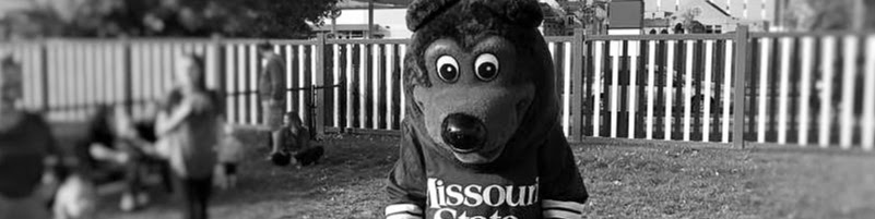 Boomer Bear on the playground with toddlers.