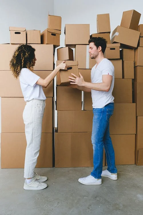 Photo by SHVETS production from Pexels: https://www.pexels.com/photo/young-couple-carrying-carton-boxes-in-new-flat-during-relocation-7203780/