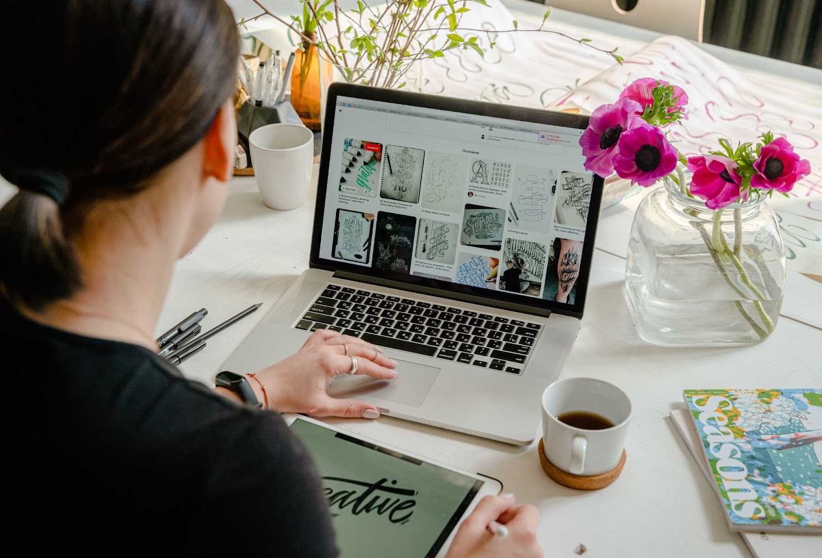 A person scrolling through computer for design concepts.