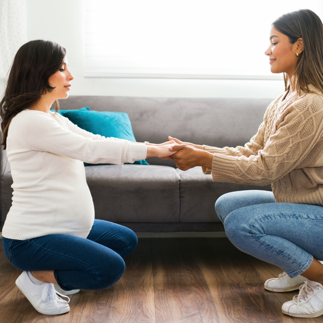 pregnant woman learning from her midwife