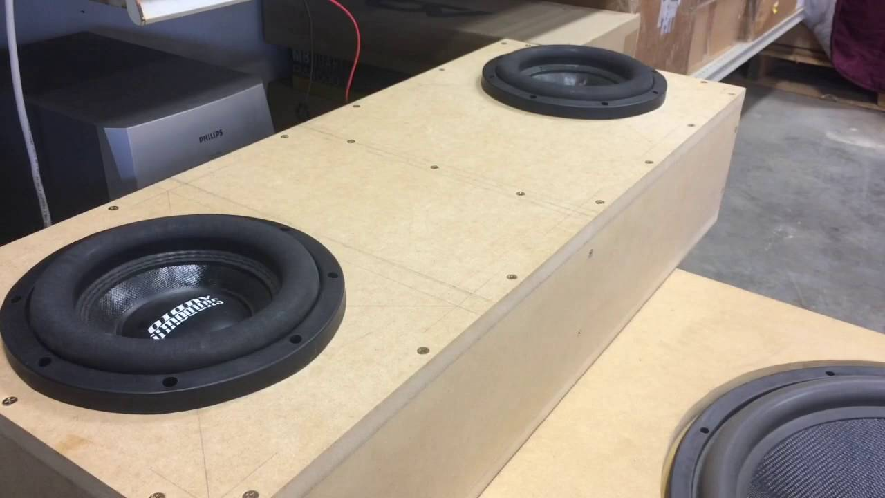 picture of 2 subwoofers boxed over another subwoofer