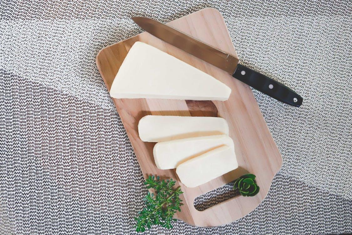 Brown Wooden Chopping Board on Green and White Textile