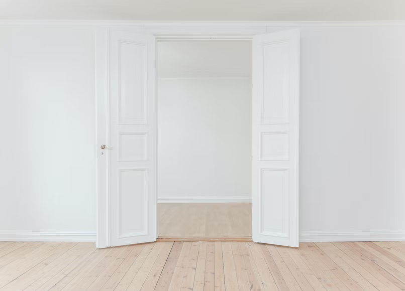 Two white doors and a white wall