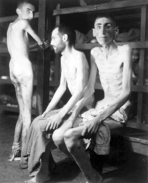 Three corpse-thin men in the barracks at Buchenwald.