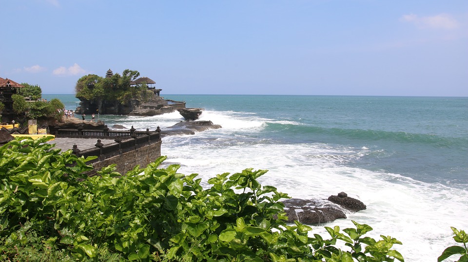 Surf breaking on a rocky coast near Bali.