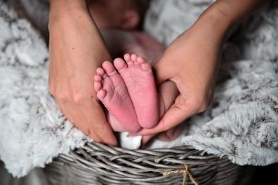 person holding baby's feet