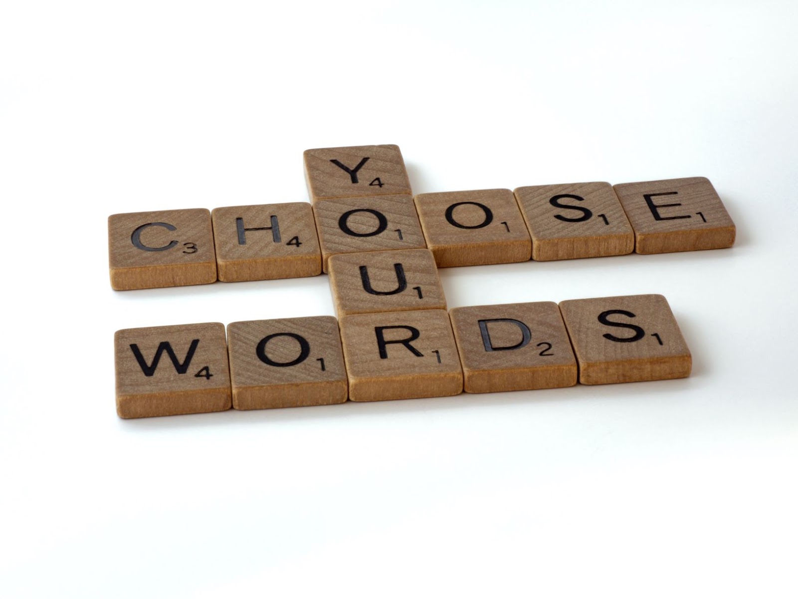 Scrabble tiles that read "Choose Your Words"