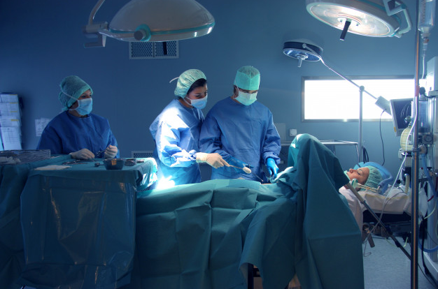 An orthopaedic surgeon performing a surgery