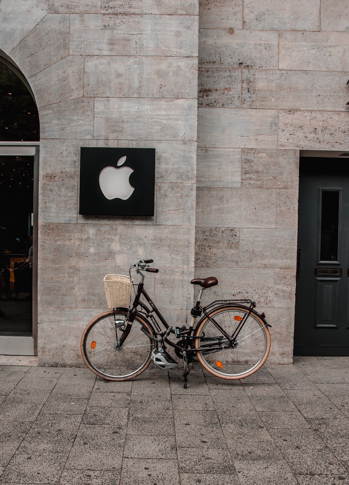 Apple logo over a bicycle on the street
