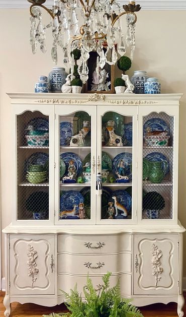 A cabinet full of China plates, chinoiserie, blue and white pottery and Staffordshire figurines. 